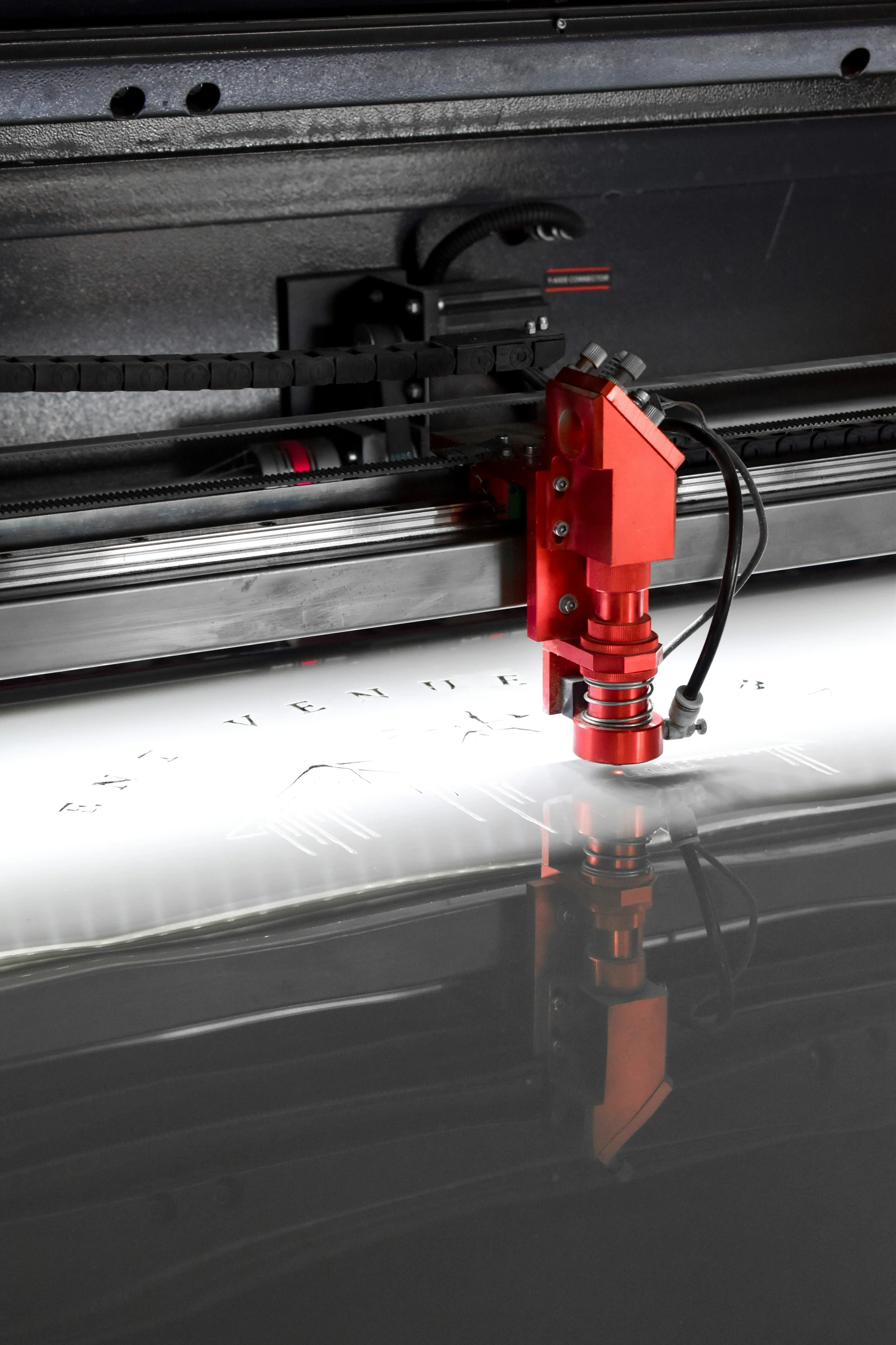Close-up of engraving equipment working on a flat material surface